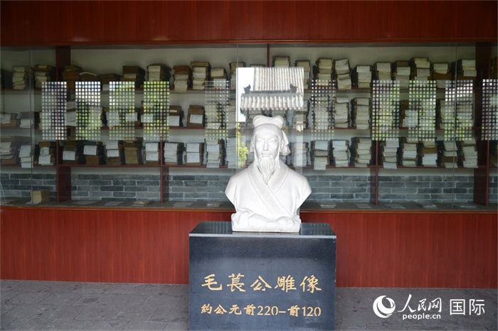 河間詩(shī)經(jīng)齋毛萇雕像。雕像后書櫥中陳列的是歷代各版本《詩(shī)經(jīng)》及譯本。 人民網(wǎng) 趙昭攝