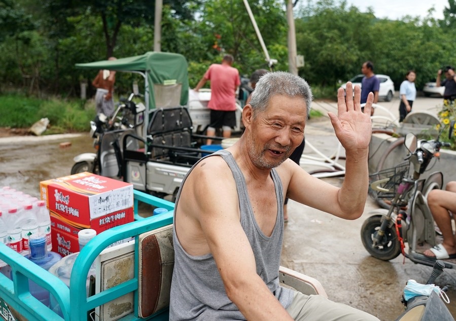 8月5日，從安置點回來的北京市房山區(qū)青龍湖鎮(zhèn)口頭村村民高大爺領到生活物資準備回家。新華社記者 張晨霖 攝