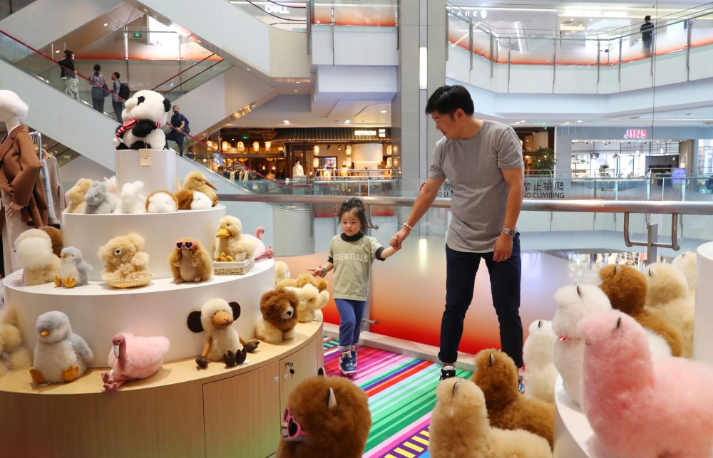 2023年11月2日，顧客在溫暖駝品牌專柜內(nèi)選購。連續(xù)六年參加進博會的秘魯羊駝制品品牌溫暖駝在上海市中心商場開設了專柜。新華社記者 方喆 攝