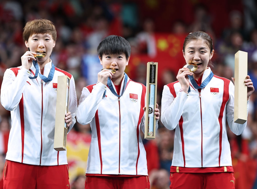 冠軍中國隊選手王曼昱、孫穎莎、陳夢（從左至右）在巴黎奧運會乒乓球女子團體頒獎儀式上（2024年8月10日攝）。新華社記者 王東震 攝