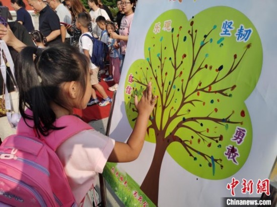 圖為衡水市利民路小學(xué)，孩子們?cè)诔砷L(zhǎng)樹(shù)的“好習(xí)慣”樹(shù)枝上按手印做出承諾。張松 攝