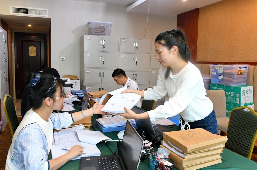 福州市委巡察機(jī)構(gòu)對全市法院系統(tǒng)開展提級聯(lián)動交叉巡察。在永泰縣駐地，巡察組工作人員查看財(cái)務(wù)憑證（2024年5月21日攝）。新華社記者 林善傳 攝